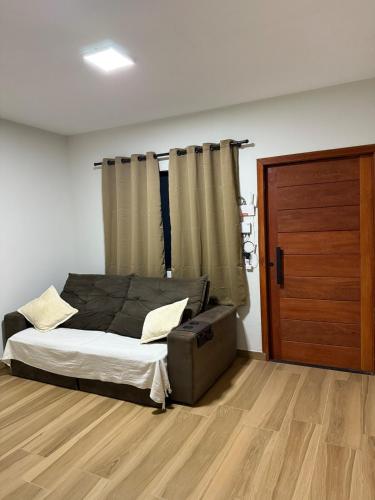 a bedroom with a bed and a wooden floor at Casa em São João del Rei in São João del Rei