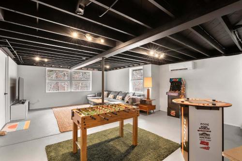 a living room with a foosball table and a couch at Tranquil Woodland Escape in Wellfleet in Wellfleet