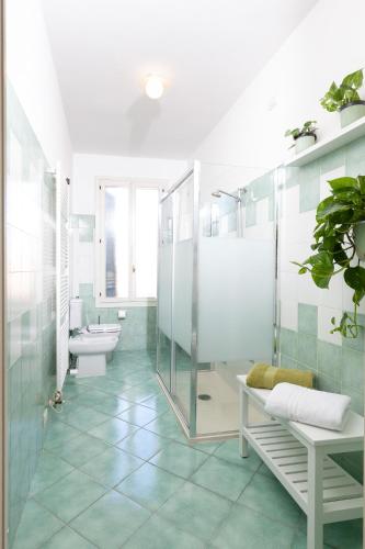 a bathroom with a shower and a toilet and a sink at Residenza Palazzo Marchesini in Bologna