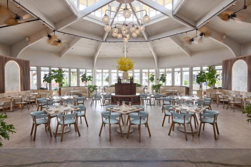 a dining room with tables and chairs and a chandelier at Hawks Cay Resort in Marathon
