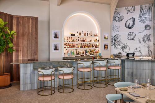a bar with a row of stools in a restaurant at Hawks Cay Resort in Marathon