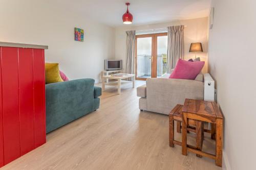 a living room with a couch and a table at Garryvoe Beach Homes in Garryvoe