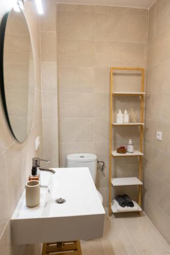 a bathroom with a white sink and a mirror at Fee4Me Menorca Ideal Apartment 700m from the Sea in Arenal d'en Castell