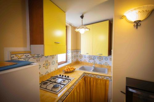 a kitchen with a sink and a stove top oven at Sunshine Apartments in Trappeto