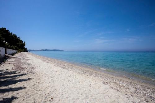 a sandy beach with the ocean in the background at Melitas Sea View Villa in Kassandria