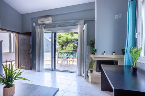 a living room with a fireplace and a table at Melitas Sea View Villa in Kassandria