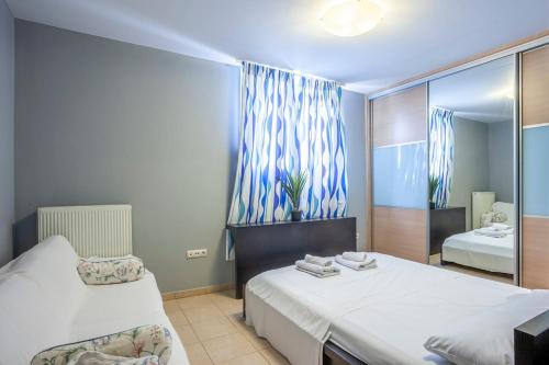 a bedroom with two beds and a mirror at Melitas Sea View Villa in Kassandria