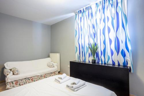 a room with a bed with a couch and a window at Melitas Sea View Villa in Kassandria