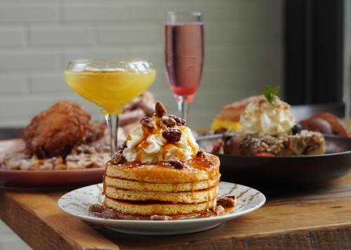 a table with a plate of pancakes and drinks at Canopy By Hilton Washington DC Bethesda North in North Bethesda