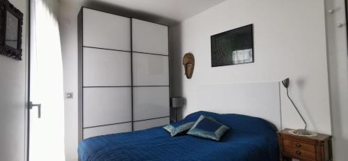 une chambre avec un lit avec un couvre-lit bleu dans l'établissement Eiffel seightseing, à Paris