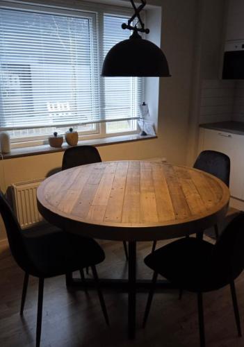 a wooden table in a kitchen with chairs around it at Studio - central and close to nature in Gothenburg