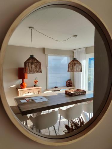 a dining room with a table and chairs in a mirror at Maison de Marcel Big house near centre free parking in Bruges