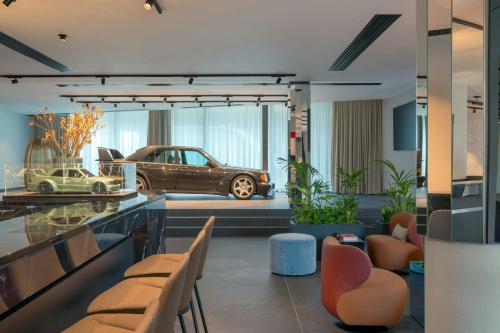 a lobby with a car on display in a building at DAS AFFALTERBACH, Stuttgart, Autograph Collection in Affalterbach