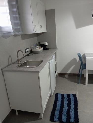 a kitchen with a sink and a counter top at La Piccola Gemma in Serramanna