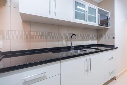 a kitchen with white cabinets and a sink at ITNC091 - Incrível vista para o mar com 3Q+3WC in Balneário Camboriú