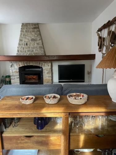 a living room with a blue couch and a fireplace at Typical house in Trebbia Valley in Cella