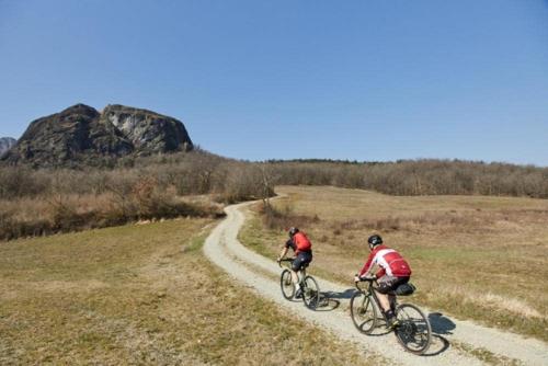 two people riding bikes down a dirt road at Typical house in Trebbia Valley in Cella