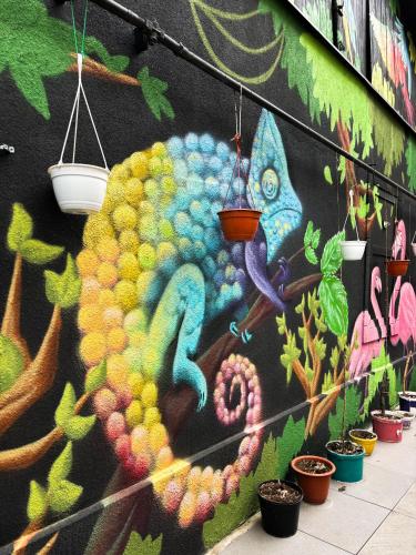 a wall with a painting of a peacock on it at Mouse House in Chişinău