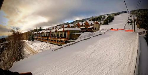 a ski slope with a ski lodge in the snow at Mountain Escape for Ski and Golf Enthusiasts in Kimberley