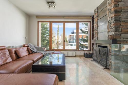 a living room with a couch and a fireplace at Scenic 2-BR Tilal Assal in Kfardebian