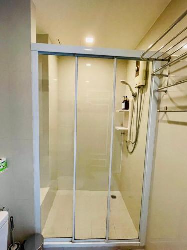 a shower with a glass door in a bathroom at The base Central luxury by Numam in Pattaya