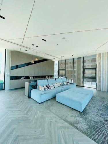 a large living room with a blue couch and tables at The base Central luxury by Numam in Pattaya