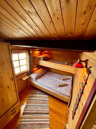 a room with two bunk beds in a cabin at Aurora cabin Tromvik in Tromsø
