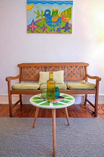 a coffee table with a bottle on it in front of a couch at Lisbonera Guest House in Lisbon