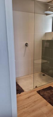 a shower with a glass door in a bathroom at 109 at Breede in Witsand