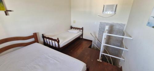 a small room with two beds and a ladder at Pousada Beijos y Abraços in Natal