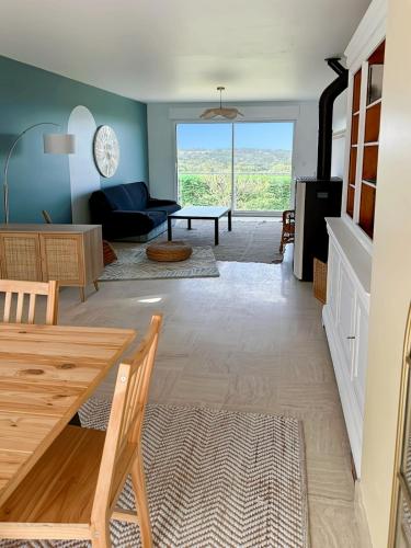 un salon avec une table et un canapé dans l'établissement L'escapade Maison familiale 3 étoiles jardin & vue mer, proche plage, à Plérin