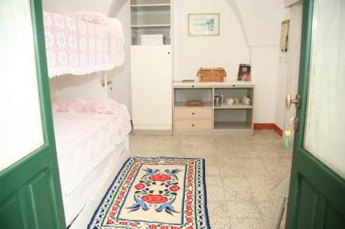 a bedroom with a bed and a rug at Monolocale Garden in Giuggianello