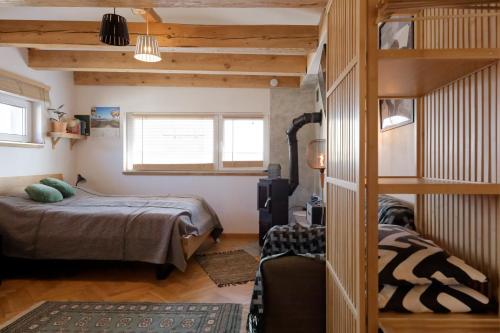 a bedroom with two bunk beds and a ladder at Studio w zabytkowej kamienicy in Gdynia