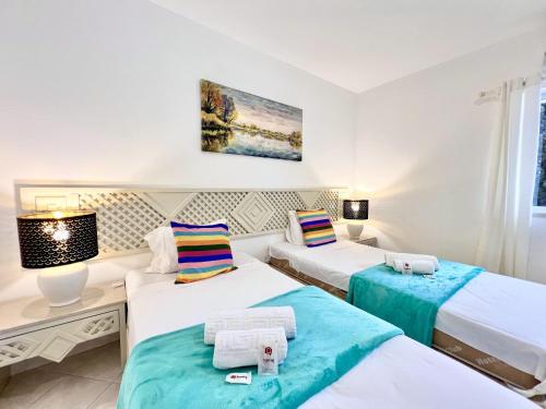 two beds in a room with white walls at Albufeira Balaia Golf Vilage 7 With Pool by Homing in Albufeira
