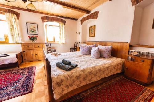 a bedroom with a bed with wooden furniture and a rug at GAJRAJ in Wünschelburg