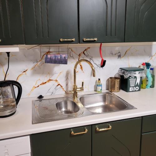a kitchen sink with a faucet on top of it at Kotimajoitus Noora in Pori