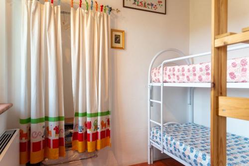 a bedroom with bunk beds and a crib at Grazioso appartamento in campagna a Procchio in Marciana