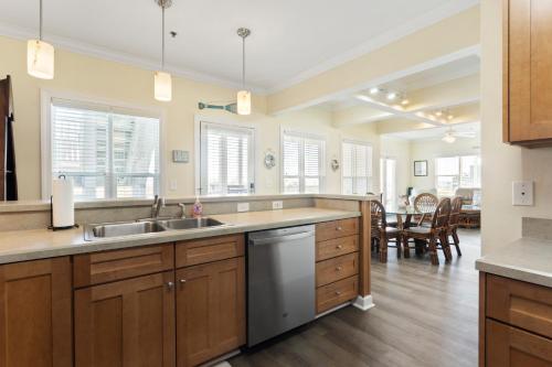a kitchen with a sink and a counter top at Oceanview 4BR/4BA Condo, Steps to Beach/Pool in Ocean Isle Beach