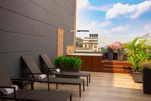 a patio with chairs and plants on a balcony at VVC Hotel's in Villavicencio