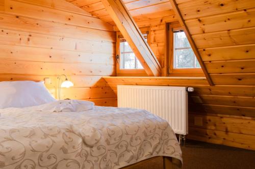 Postel nebo postele na pokoji v ubytování Hotel Grůň