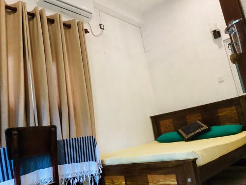 a bedroom with a bed and a curtain at Nila Villa in Galle