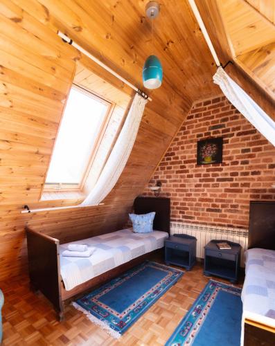 a room with a couch in a room with a brick wall at GAJRAJ in Wünschelburg