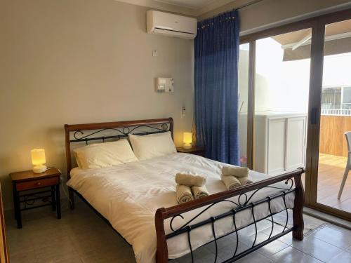a bedroom with a bed with teddy bears on it at City Center Apartments in Mellieħa