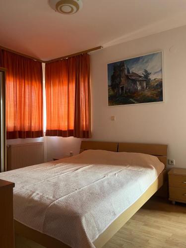 a bedroom with a bed and a painting on the wall at Lavanda Apartments in Pakoštane
