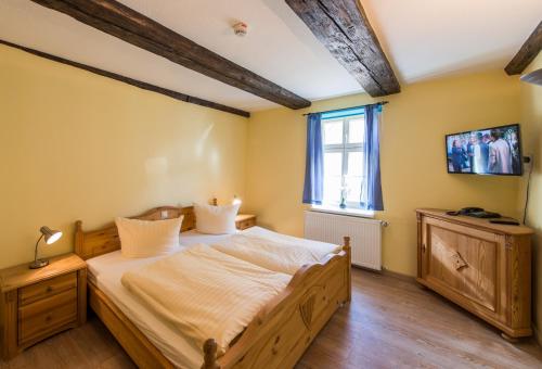 a bedroom with a large bed and a window at Maria Aurora in Quedlinburg
