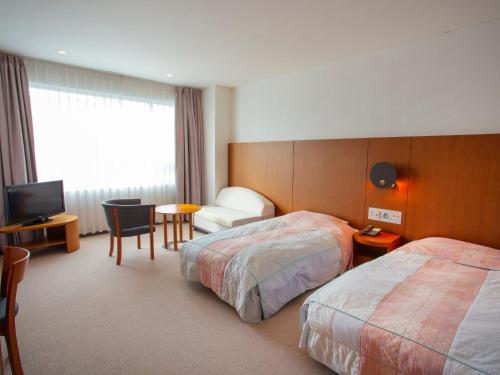 Ένα ή περισσότερα κρεβάτια σε δωμάτιο στο ANA Crowne Plaza Resort Appi Kogen by IHG