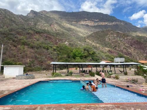 a group of people standing in a swimming pool at Finca la playita in Jordán