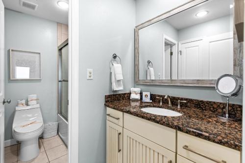 a bathroom with a sink and a toilet and a mirror at Silver Sands Townhomes Unit 4 in Inlet Beach