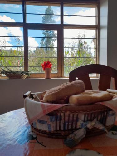 a basket sitting on a table in front of a window at Pisonaywasi - Hospedaje familiar in Urubamba