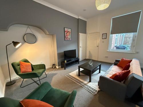 a living room with a couch and chairs and a television at Bexley-4 Bdrm 5 beds Sleeps 7 Ideal 4 Contractors in Pallion